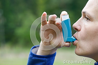 Asthma patient inhaling medication Stock Photo