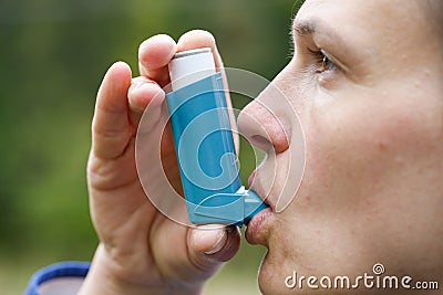 Asthma patient inhaling medication Stock Photo