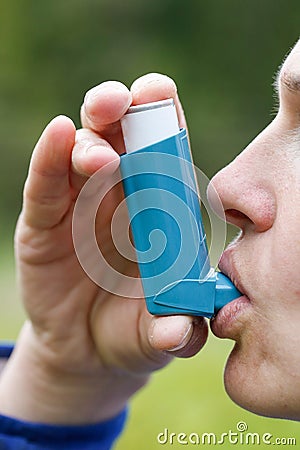 Asthma patient inhaling medication Stock Photo