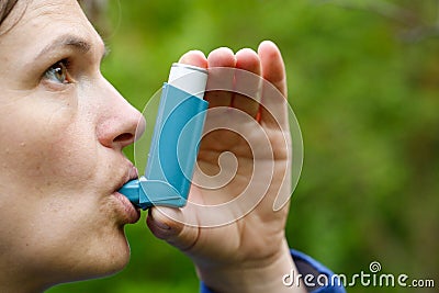 Asthma patient inhaling medication Stock Photo