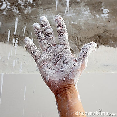 Astist plastering man hand with cracked plaster Stock Photo