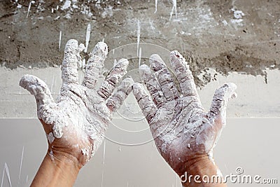 Astist plastering man hands with cracked plaster Stock Photo