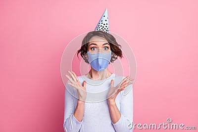 Astonished expression girl wear birthday cap jumper sweater medical mask isolated pastel color background Stock Photo