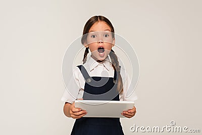 astonished schoolkid with digital tablet looking Stock Photo