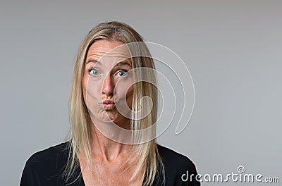 Astonished woman staring wide eyed at camera Stock Photo