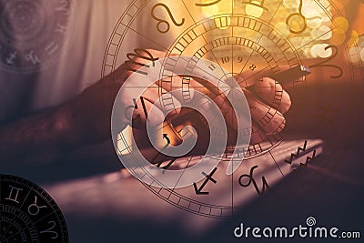 Astrologer using mobile smart phone app and computer to make predictions on future outcome Stock Photo