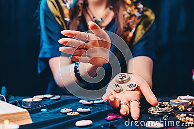 Astrology and magic. A witch holds a stones with the sign of the zodiac. Close up. The concept of horoscopes and telling Stock Photo