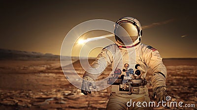 Astronaut exploring the surface of red planet Mars. Stock Photo