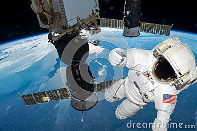 astronaut float in the space in weightlessness working on the spaceship near to planet earth Elements of this image Stock Photo