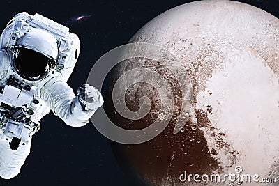 Astronaut near Planet Pluto in space Stock Photo
