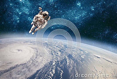 Astronaut in outer space against the backdrop of the planet earth. Typhoon over planet Earth Stock Photo