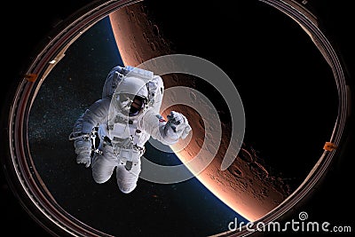 Astronaut in outer space from porthole on background of the Mars. Elements of this image furnished by NASA Stock Photo