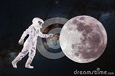 Astronaut in space and moon exploration. Concept, astronaut pulls his hand to the lunar surface Stock Photo