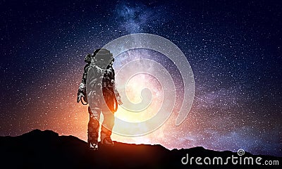 Astronaut walking on an unexplored planet Stock Photo