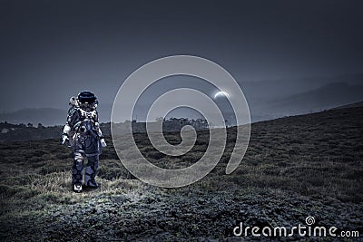 Astronaut walking on an unexplored planet Stock Photo