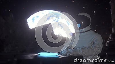 Astronaut works on his science laptop in a space colony on the moon. 3d rendering Stock Photo