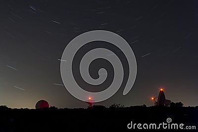 Astronomical observatory with trail stars in a night. Stock Photo