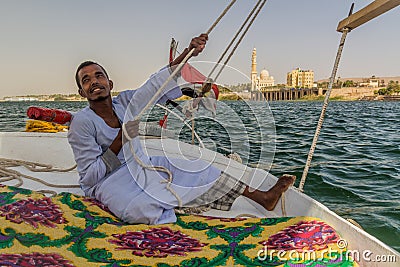 ASWAN, EGYPT: FEB 15, 2019: Crewman of a felucca sail boat at the river Nile near Aswan, Egy Editorial Stock Photo