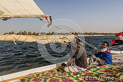 ASWAN, EGYPT: FEB 15, 2019: Crewmen of a felucca sail boat at the river Nile, Egy Editorial Stock Photo