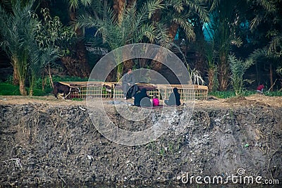 Aswan, Egypt, 24th of December 2018: Daily life on the riverside Nile in Egypt. Poor people living Editorial Stock Photo