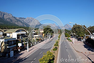 Ataturk Boulevard in Kemer and Taurus mountains at far on a bright sunny day Stock Photo