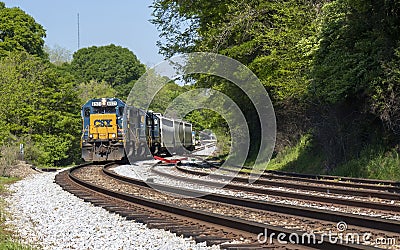 CSX engine 6921 pulls a small load around a curve in the railroad track. Editorial Stock Photo