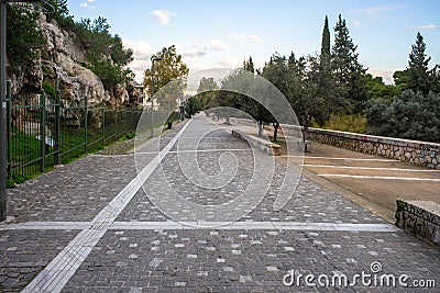 Athens, Greece, Dionysiou Areopagitou street, early morning with no people. Pedestrian walkway under acropolis hill Stock Photo