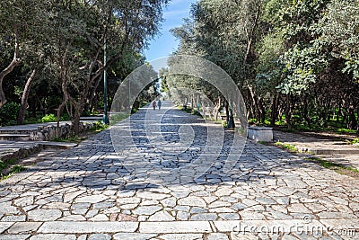 Athens, Greece. People walk on a cobblestone pathway at Filopappou hill Stock Photo