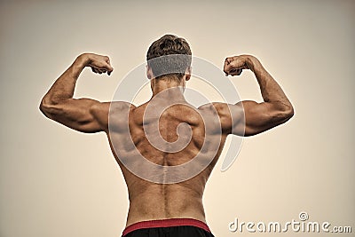 Athlete with bare torso on grey sky Stock Photo