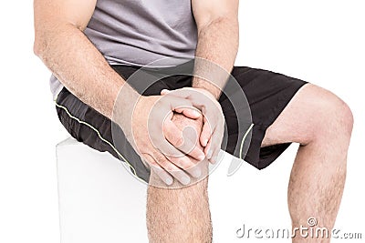 Athlete clutching knee in excruciating pain Stock Photo