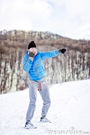 Athlete fighter doing a practice training on snow, exercising Stock Photo