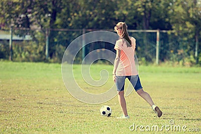 Athlete girl kicks the ball played soccer Stock Photo