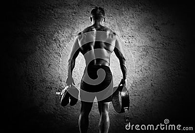 The athlete goes to the gym for training. In his hands he holds Stock Photo