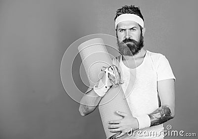 Athlete guide stay in shape. Man bearded athlete hold fitness mat and tape measure. Athlete professional coach motivated Stock Photo