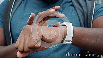 Athlete hands using smartwatch outdoors. Jogger checking results on smart watch Stock Photo