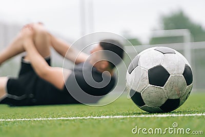 Athlete A man holds on to his knee. Dislocation of the knee joint. The concept of falling during sports Stock Photo