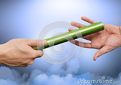 Athlete passing the baton to teammate Stock Photo