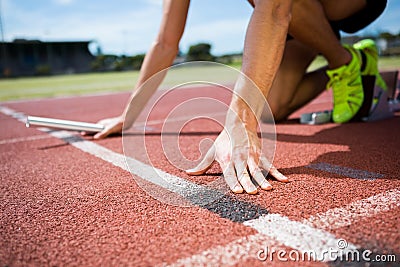 Athlete ready to start the relay race Stock Photo