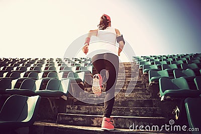 Athlete running on stairs. woman fitness jogging workout wellness concept. Stock Photo