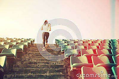 Athlete running on stairs. woman fitness jogging workout wellness concept. Stock Photo