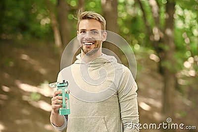 Athlete satisfied face hold bottle care hydration body after workout. Refreshing vitamin drink after great workout. Man Stock Photo