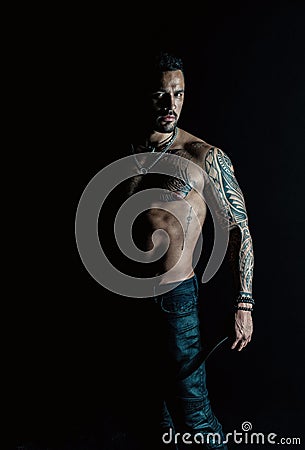 Athlete or sportsman with muscular chest and belly. Tattoo model with six pack and ab. Bearded man with tattooed body Stock Photo