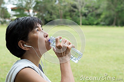 Athlete woman drinking water after exercise Stock Photo