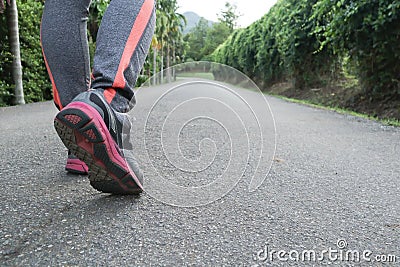 Athlete woman`s feet with running shoe walking in public park.female active lifestyle for future competition concept Stock Photo