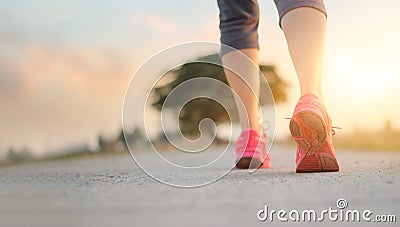 Athlete woman walking exercise on rural road in sunset background, healthy and lifestyle concept Stock Photo
