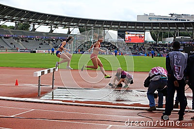 Athletes COMPETE on the 3000 meters steeple Editorial Stock Photo