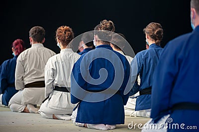Athletes of Karate black belt kneeling in Seiza position, from behind Editorial Stock Photo