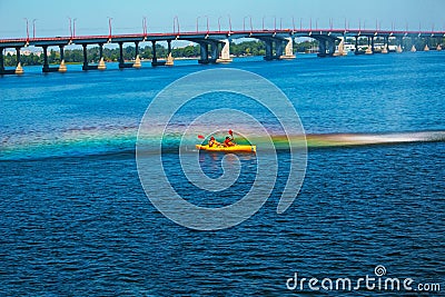 Athletes in kayaks in training near the river fountain in a rainbow of splashes Editorial Stock Photo