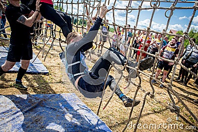 Athletes overcome obstacles in the adventure race Editorial Stock Photo