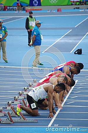 Athletes at start line of 100m sprint run Editorial Stock Photo